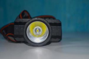 Selective focus LED headlamp on isolated blue background photo