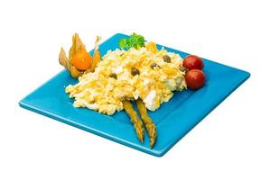 Scrambled eggs on the plate and white background photo
