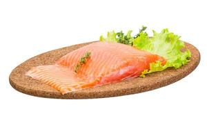 Salmon fillet on wooden board and white background photo