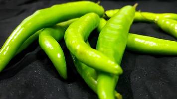 Fresh green chili on black background photo