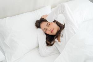 Girl lying in bed unwell suffers from insomnia headacheAnxiety, holding your head photo