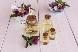 Various glass bottles with stopper with organic natural herbal oil. healing therapy. natural care. white background. selective focus. photo