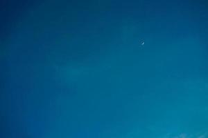 Crescent moon with empty blue sky copy space for banner or wallpaper background photo