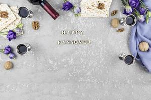 festive background of the Jewish Passover. traditional products for the holiday. flat lay, top view, gray concrete background with letters- passover. photo