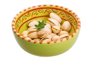 Pistachio in a bowl on white background photo