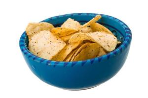 Potato chips in a bowl on white background photo