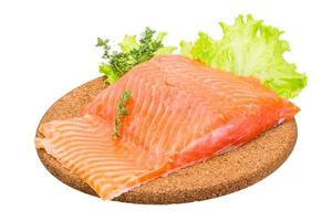 Salmon fillet on wooden board and white background photo