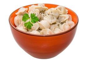 Russian dumplings in a bowl on white background photo