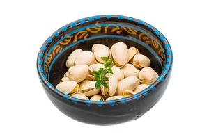 Pistachio in a bowl on white background photo