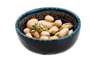 Pistachio in a bowl on white background photo