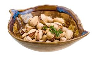 Pistachio in a bowl on white background photo