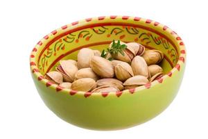 Pistachio in a bowl on white background photo