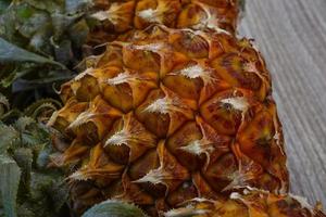 Small pineapple on wood photo