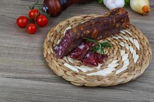 Salami sausage on wood photo