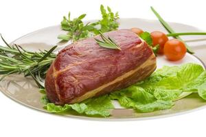 carne de res ahumada en el plato y fondo blanco foto