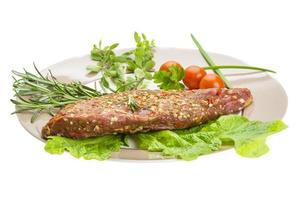 Smoked beef on the plate and white background photo