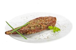 Smoked beef on the plate and white background photo