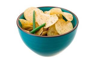 Potato chips in a bowl on white background photo