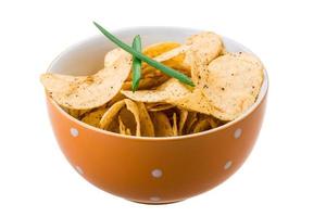 Potato chips in a bowl on white background photo