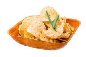 Potato chips in a bowl on white background photo