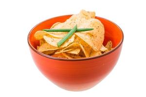 Potato chips in a bowl on white background photo