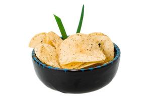 Potato chips in a bowl on white background photo