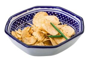 Potato chips in a bowl on white background photo