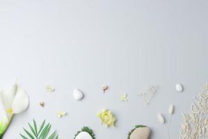 Cosmetic background with flowers, moss and stone on grey. Flat lay, copy space photo