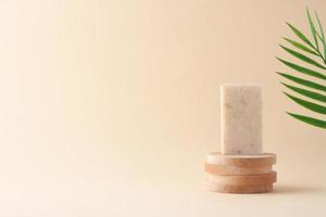Soap with palm on beige background. Close up, copy space. photo