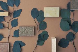 Soap with eucalyptus on brown natural background. Flat lay, copy space. photo