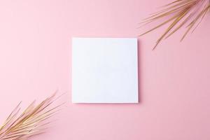 Minimal composition with palm leaf on pink background. Flat lay, copy space photo