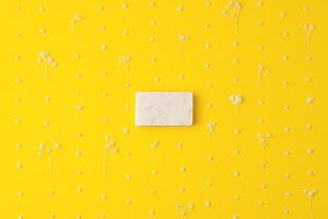 Soap and flower on yellow background. Flat lay, copy space. photo