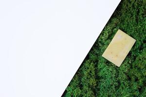 Natural background with green moss and soap. Flat lay, copy space. photo