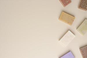 Soap on beige background. Flat lay, copy space. photo