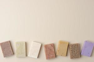 Soap on beige background. Flat lay, copy space. photo