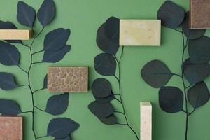 Soap with eucalyptus on green natural background. Flat lay, copy space. photo