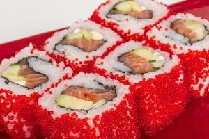 Tobiko Spicy Maki Sushi - Hot Roll with various type of flying fish roe outside. Salmon, avocado and Green Lettuce inside photo