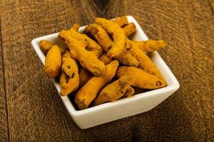 Tumeric roots on wood photo