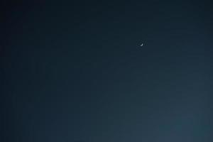 Crescent moon with empty blue sky copy space for banner or wallpaper background photo