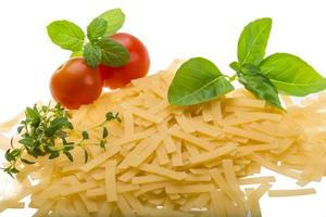 Raw macaroni on white background photo