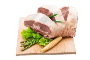 Raw lamb on wooden board and white background photo
