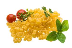 Raw macaroni on white background photo