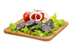 Horse sausages on the plate and white background photo