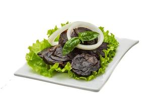 Horse sausages in a bowl on white background photo