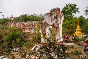 Elephant sculpture in old temple with numerous of old Image of Buddha on mountain in Mingun, Sagaing Region, Myanmar photo