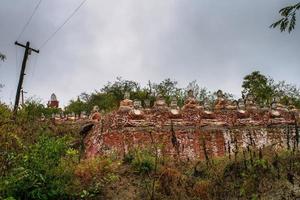 Old temple with numerous of old Image of Buddha on mountain in Mingun, Sagaing Region, Myanmar photo