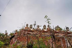 Old temple with numerous of old Image of Buddha on mountain in Mingun, Sagaing Region, Myanmar photo