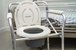 Flush toilet and shower chair in bathroom for old elder people. photo