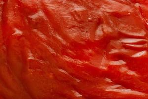 Tomato sauce ketchup texture background close up photo