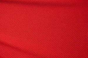 Red sports clothing fabric football jersey texture close up photo